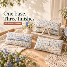Three blue floral diaper wallets show separate ivory tie, gathered blue gingham strap, and narrow loop-and-button closures among fabric and flowers.