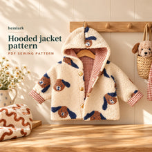 A complete cream dog-print sherpa and rust gingham hooded jacket hangs on a wooden display. Long sleeves, turned cuffs, gold snap front and full lining. Digital PDF sewing pattern.