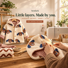 Hands sew the curved hood seam at a machine with a completed cream dog-print sherpa and rust gingham hooded jacket nearby. Digital sewing pattern.