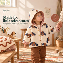Child wears the cream dog-print sherpa and rust gingham hooded jacket with the hood up. Lined sleeves and gold snap front are visible. Digital PDF pattern.