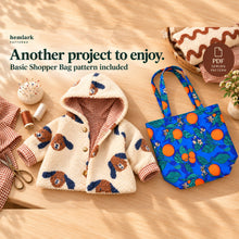 A two-handle Basic Shopper Bag in citrus-print woven fabric is styled beside a sample jacket. The bonus bag pattern is included as a separate sewing project.