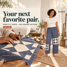 Adult woman in slate-blue elastic-waist pants with ivory star patches beside hands stitching a matching patch to a flat leg panel. Mom-Fit Pants PDF pattern, XS-3XL.