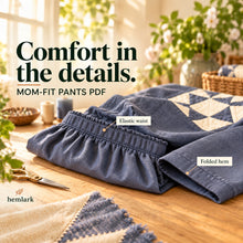 Close-up of the slate-blue woven pants shows the elastic waistband and plain folded hem. Hemlark Mom-Fit Pants PDF sewing pattern.
