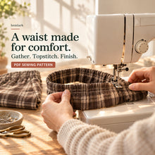 Waistband construction close-up showing rich cocoa-brown and warm cream windowpane plaid wide-leg pants with elastic waist and front pockets. Hemlark digital sewing pattern.